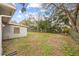 Spacious backyard with grassy area and mature trees at 2049 Jefferson Ave, Deltona, FL 32738