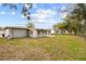 Large backyard with grassy area and a patio at 2049 Jefferson Ave, Deltona, FL 32738
