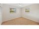 Cozy carpeted bedroom with two windows and ceiling fan at 2049 Jefferson Ave, Deltona, FL 32738