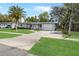 Charming single-story home with a well-manicured lawn and a beautiful mature palm tree at 2049 Jefferson Ave, Deltona, FL 32738