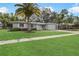 Charming single-story home with a well-manicured lawn and a beautiful mature palm tree at 2049 Jefferson Ave, Deltona, FL 32738