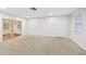Spacious living room with neutral carpet, recessed lighting and sliding doors to additional room at 2049 Jefferson Ave, Deltona, FL 32738