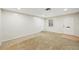 Bright living room featuring neutral carpeting and an interior door at 2049 Jefferson Ave, Deltona, FL 32738