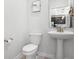 Powder room with pedestal sink and toilet at 2089 Camden Loop, Davenport, FL 33837