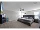 King-size bedroom with large TV and ceiling fan at 2089 Camden Loop, Davenport, FL 33837