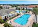 Aerial view of community pool with water features, lounging areas, and clubhouse at 2089 Camden Loop, Davenport, FL 33837