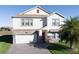 Two-story home with a red door and stone accents at 2089 Camden Loop, Davenport, FL 33837