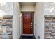 Red front door with stone accents at 2089 Camden Loop, Davenport, FL 33837