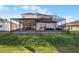 Two-story house with covered patio and lush lawn at 2089 Camden Loop, Davenport, FL 33837
