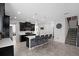 Modern kitchen with island, stainless steel appliances, and dark cabinetry at 2089 Camden Loop, Davenport, FL 33837