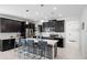 Modern kitchen with an island and dark cabinetry at 2089 Camden Loop, Davenport, FL 33837