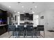 Modern kitchen with large island and dark cabinetry, open to living area at 2089 Camden Loop, Davenport, FL 33837