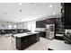Open concept kitchen features a large island and stainless steel appliances at 2089 Camden Loop, Davenport, FL 33837