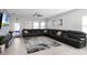 Living room features a large sectional sofa and a stone accent wall at 2089 Camden Loop, Davenport, FL 33837