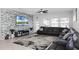 Spacious living area with sectional sofa and stone feature wall at 2089 Camden Loop, Davenport, FL 33837
