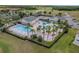 Community pool with water slide, lounge chairs, and palm trees at 2089 Camden Loop, Davenport, FL 33837