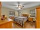 Cozy bedroom with wood floors and ceiling fan at 2770 Windsong Ln, St Cloud, FL 34772