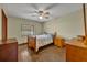 Well-lit bedroom with wood floors and ceiling fan at 2770 Windsong Ln, St Cloud, FL 34772