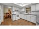 White kitchen with ample counter space and adjacent dining area at 2770 Windsong Ln, St Cloud, FL 34772