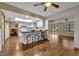 Kitchen with breakfast bar, white cabinets, and access to the dining area at 2770 Windsong Ln, St Cloud, FL 34772