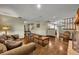 Living room with stone fireplace, hardwood floors, and adjacent kitchen at 2770 Windsong Ln, St Cloud, FL 34772