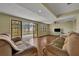 Living room with tile floors, sliding doors to patio, and neutral decor at 2770 Windsong Ln, St Cloud, FL 34772