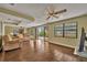 Living room with tile floors, sliding glass doors and ceiling fan at 2770 Windsong Ln, St Cloud, FL 34772