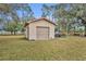 Detached workshop with garage door in the backyard at 2770 Windsong Ln, St Cloud, FL 34772