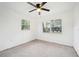 Spacious, carpeted bedroom with two windows at 3115 Avenue U Nw, Winter Haven, FL 33881