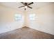 Empty bedroom with ceiling fan and two windows for natural light at 3115 Avenue U Nw, Winter Haven, FL 33881