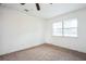 Bright bedroom featuring neutral carpet, ceiling fan, and a window at 3115 Avenue U Nw, Winter Haven, FL 33881