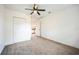 Bedroom with a ceiling fan, closet, and doorway view into the kitchen at 3115 Avenue U Nw, Winter Haven, FL 33881