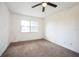 Bedroom with a ceiling fan, window, and neutral carpet at 3115 Avenue U Nw, Winter Haven, FL 33881