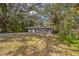 Quaint single-story home with a concrete driveway, set amid mature trees at 3115 Avenue U Nw, Winter Haven, FL 33881