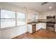 Bright eat-in kitchen with white cabinets, stainless appliances, and large window overlooking the backyard at 3115 Avenue U Nw, Winter Haven, FL 33881