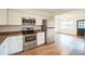 Well-lit kitchen featuring stainless steel appliances, granite countertops and new white cabinets at 3115 Avenue U Nw, Winter Haven, FL 33881