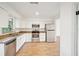 Well-lit kitchen featuring stainless steel appliances, granite countertops and new white cabinets at 3115 Avenue U Nw, Winter Haven, FL 33881