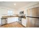 Updated kitchen featuring stainless steel appliances, granite countertops, and wood-look floors at 3115 Avenue U Nw, Winter Haven, FL 33881