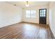 Bright living room with new luxury vinyl plank flooring, new paint and a new exterior door at 3115 Avenue U Nw, Winter Haven, FL 33881
