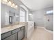 Large bathroom featuring a walk-in shower and soaking tub at 3291 Pawleys N Loop, St Cloud, FL 34769