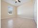 Bright bedroom with tile floors and a large window with blinds at 3291 Pawleys N Loop, St Cloud, FL 34769