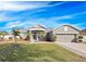 Single-story house with a two-car garage and palm trees at 3291 Pawleys N Loop, St Cloud, FL 34769