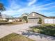 House exterior with a driveway and landscaped lawn at 3291 Pawleys N Loop, St Cloud, FL 34769