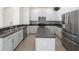 Updated kitchen with stainless steel appliances and an island at 3291 Pawleys N Loop, St Cloud, FL 34769