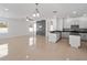 Open living room and kitchen area with a stone accent wall at 3291 Pawleys N Loop, St Cloud, FL 34769