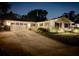 Well-lit home exterior at night with a spacious driveway at 3458 Balsam Dr, Winter Park, FL 32792