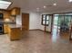 Open kitchen with breakfast bar, wood cabinets, and tiled floor at 3458 Balsam Dr, Winter Park, FL 32792