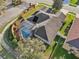 An aerial shot of the home featuring the lawn, pool, landscaping, and fencing at 369 Belhaven Falls Dr, Ocoee, FL 34761
