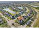 Aerial view of a community featuring well-maintained landscaping, multiple ponds, and neatly arranged houses at 369 Belhaven Falls Dr, Ocoee, FL 34761