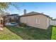 A side view of the backyard featuring a screened-in pool, green grass, and shrubbery at 369 Belhaven Falls Dr, Ocoee, FL 34761